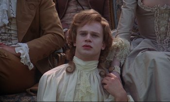 Movie still from “Barry Lyndon” (1975), directed by Stanley Kubrick – A young man with long hair is getting his hair combed; Close Up shot, High angle