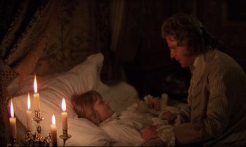 Movie still from “Barry Lyndon” (1975), directed by Stanley Kubrick – A woman and a little girl laying in a bed next to a lit candle; Medium shot, High angle