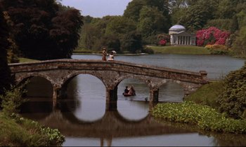 Movie still from “Barry Lyndon” (1975), directed by Stanley Kubrick – A bridge over a body of water with people on it; Extreme Wide shot, High angle