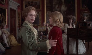 Movie still from “Barry Lyndon” (1975), directed by Stanley Kubrick – Two young people are dancing in an old - fashioned setting; Medium shot, Over the shoulder angle
