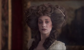 Movie still from “Barry Lyndon” (1975), directed by Stanley Kubrick – A woman with a long , curly hair style; Close Up shot, Over the shoulder angle