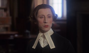 Movie still from “Barry Lyndon” (1975), directed by Stanley Kubrick – A man in a black and white suit and white collar; Close Up shot, Over the shoulder angle