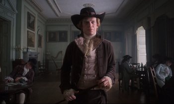 Movie still from “Barry Lyndon” (1975), directed by Stanley Kubrick – A man wearing a hat and holding a cane; Medium shot, Low angle