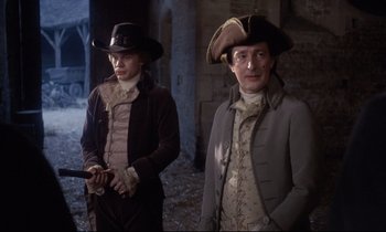 Movie still from “Barry Lyndon” (1975), directed by Stanley Kubrick – Two men dressed in period clothing standing next to each other; Medium shot, Over the shoulder angle