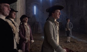 Movie still from “Barry Lyndon” (1975), directed by Stanley Kubrick – A group of people standing around in a room; Medium shot, Low angle