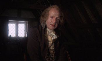 Movie still from “Barry Lyndon” (1975), directed by Stanley Kubrick – An old man sitting in a chair in a dark room; Medium shot, Over the shoulder angle