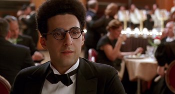 Movie still from “Barton Fink” (1991), directed by Joel Coen – A man in a suit and bow tie; Close Up shot, Over the shoulder angle