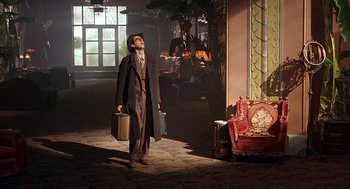 Movie still from “Barton Fink” (1991), directed by Joel Coen – A man in a suit and hat holding a briefcase; Wide shot, Low angle