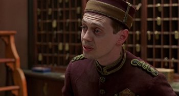 Movie still from “Barton Fink” (1991), directed by Joel Coen – A man in a uniform is looking at the camera; Close Up shot, High angle