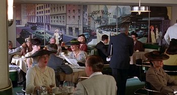 Movie still from “Barton Fink” (1991), directed by Joel Coen – A group of people sitting at a table in a restaurant; Wide shot, Over the shoulder angle