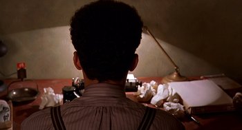 Movie still from “Barton Fink” (1991), directed by Joel Coen – A man is looking at a pile of papers on the floor; Close Up shot, Low angle