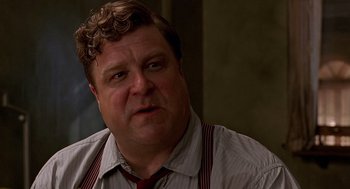 Movie still from “Barton Fink” (1991), directed by Joel Coen – A person wearing a shirt and a tie; Close Up shot, Over the shoulder angle