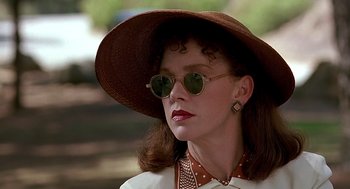 Movie still from “Barton Fink” (1991), directed by Joel Coen – A woman wearing a hat and sunglasses in a park; Close Up shot, Low angle