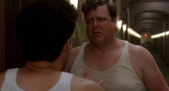 Movie still from “Barton Fink” (1991), directed by Joel Coen – A man looking at himself in the mirror in front of a mirror; Close Up shot, Over the shoulder angle