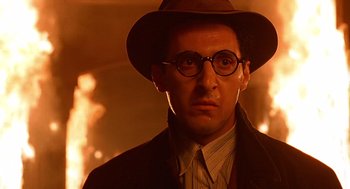 Movie still from “Barton Fink” (1991), directed by Joel Coen – A man in a hat and glasses wearing a suit and tie; Close Up shot, Low angle