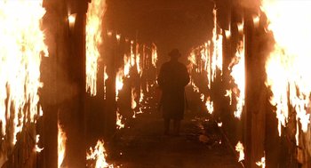 Movie still from “Barton Fink” (1991), directed by Joel Coen – A man standing in front of a fire tunnel; Wide shot, Low angle