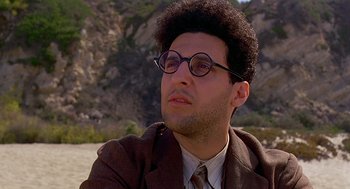 Movie still from “Barton Fink” (1991), directed by Joel Coen – A man in a suit and glasses looking to his left; Close Up shot, Low angle