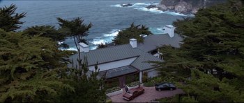 Movie still from “Basic Instinct” (1992), directed by Paul Verhoeven – An aerial view of a house with a car parked in front of it; Extreme Wide shot, High angle