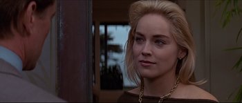 Movie still from “Basic Instinct” (1992), directed by Paul Verhoeven – A person wearing a necklace; Close Up shot, Over the shoulder angle