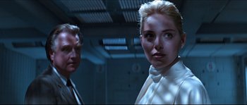 Movie still from “Basic Instinct” (1992), directed by Paul Verhoeven – A man and a woman standing next to each other; Close Up shot, Low angle