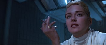Movie still from “Basic Instinct” (1992), directed by Paul Verhoeven – A person holding a cigarette in their hand; Close Up shot, Low angle