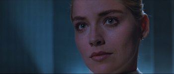 Movie still from “Basic Instinct” (1992), directed by Paul Verhoeven – A woman's face in a dark room; Close Up shot, Over the shoulder angle
