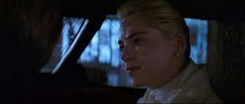 Movie still from “Basic Instinct” (1992), directed by Paul Verhoeven – A woman with blonde hair sitting in a car; Close Up shot, Over the shoulder angle
