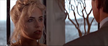 Movie still from “Basic Instinct” (1992), directed by Paul Verhoeven – A person with blonde hair; Close Up shot, Over the shoulder angle