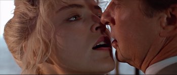 Movie still from “Basic Instinct” (1992), directed by Paul Verhoeven – A man and a woman kissing each other; Extreme Close Up shot, Low angle