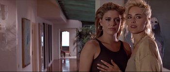 Movie still from “Basic Instinct” (1992), directed by Paul Verhoeven – A beautiful woman standing in front of a room; Close Up shot, Low angle