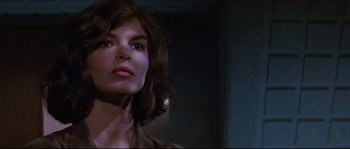Movie still from “Basic Instinct” (1992), directed by Paul Verhoeven – A person wearing a brown shirt; Close Up shot, Low angle