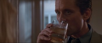 Movie still from “Basic Instinct” (1992), directed by Paul Verhoeven – A person drinking a glass of water; Close Up shot, Low angle