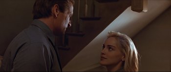 Movie still from “Basic Instinct” (1992), directed by Paul Verhoeven – A man and a woman looking at one another; Close Up shot, Low angle