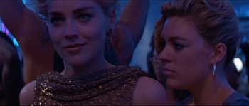 Movie still from “Basic Instinct” (1992), directed by Paul Verhoeven – Two beautiful women sitting next to each other in a room; Close Up shot, Over the shoulder angle