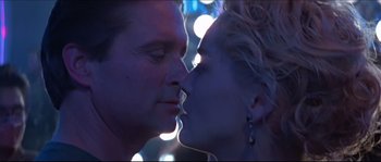 Movie still from “Basic Instinct” (1992), directed by Paul Verhoeven – A man and a woman kissing in front of lights; Close Up shot, Low angle