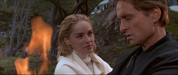 Movie still from “Basic Instinct” (1992), directed by Paul Verhoeven – A man and a woman standing next to each other outside; Close Up shot, Over the shoulder angle