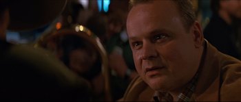 Movie still from “Basic Instinct” (1992), directed by Paul Verhoeven – A person wearing a suit and tie; Close Up shot, Over the shoulder angle