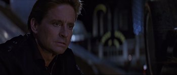Movie still from “Basic Instinct” (1992), directed by Paul Verhoeven – A person wearing a black jacket; Close Up shot, Low angle