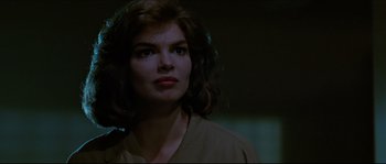 Movie still from “Basic Instinct” (1992), directed by Paul Verhoeven – A person wearing a brown shirt; Close Up shot, Low angle