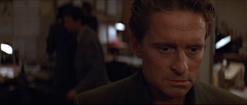 Movie still from “Basic Instinct” (1992), directed by Paul Verhoeven – A man's face in a dark room; Close Up shot, Over the shoulder angle