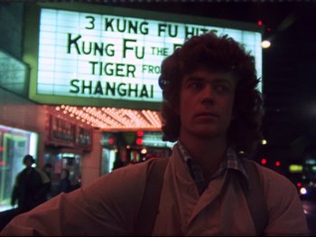 A man standing in front of a movie screen