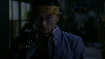 Movie still from “Battle Royale” (2000), directed by Kinji Fukasaku – A man with a bandage on his head; Close Up shot, Low angle