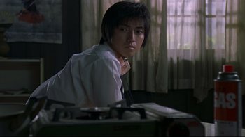 Movie still from “Battle Royale” (2000), directed by Kinji Fukasaku – A man in a white dress shirt and a tie; Medium shot, Low angle