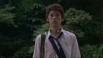 Movie still from “Battle Royale” (2000), directed by Kinji Fukasaku – A young man wearing a white shirt and a black neck tie; Close Up shot, Low angle