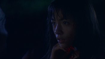Movie still from “Battle Royale” (2000), directed by Kinji Fukasaku – A woman with a bloody bandage on her face; Close Up shot, Low angle