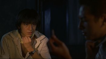 Movie still from “Battle Royale” (2000), directed by Kinji Fukasaku – A young man looking at his reflection in a mirror; Close Up shot, Over the shoulder angle