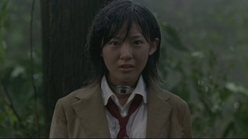 Movie still from “Battle Royale” (2000), directed by Kinji Fukasaku – A person wearing a suit and a tie; Close Up shot, Low angle