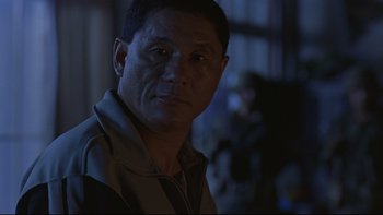 Movie still from “Battle Royale” (2000), directed by Kinji Fukasaku – A person wearing a jacket; Close Up shot, Low angle