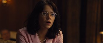 Movie still from “Battle of the Sexes” (2017), directed by Valerie Faris – A woman wearing glasses and a pearl necklace; Close Up shot, Over the shoulder angle