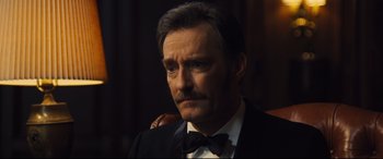 Movie still from “Battle of the Sexes” (2017), directed by Valerie Faris – A person wearing a suit and a bow tie; Close Up shot, Low angle